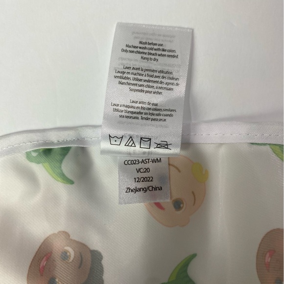 CoComelon pocket feeding bib white with dinosaurs and faces - Picture 4 of 6